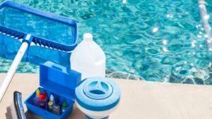 Pool cleaning and maintenance elements sit on the side of a crystal-clear pool.