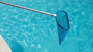 A pool net extends out over a crystal-clear pool.